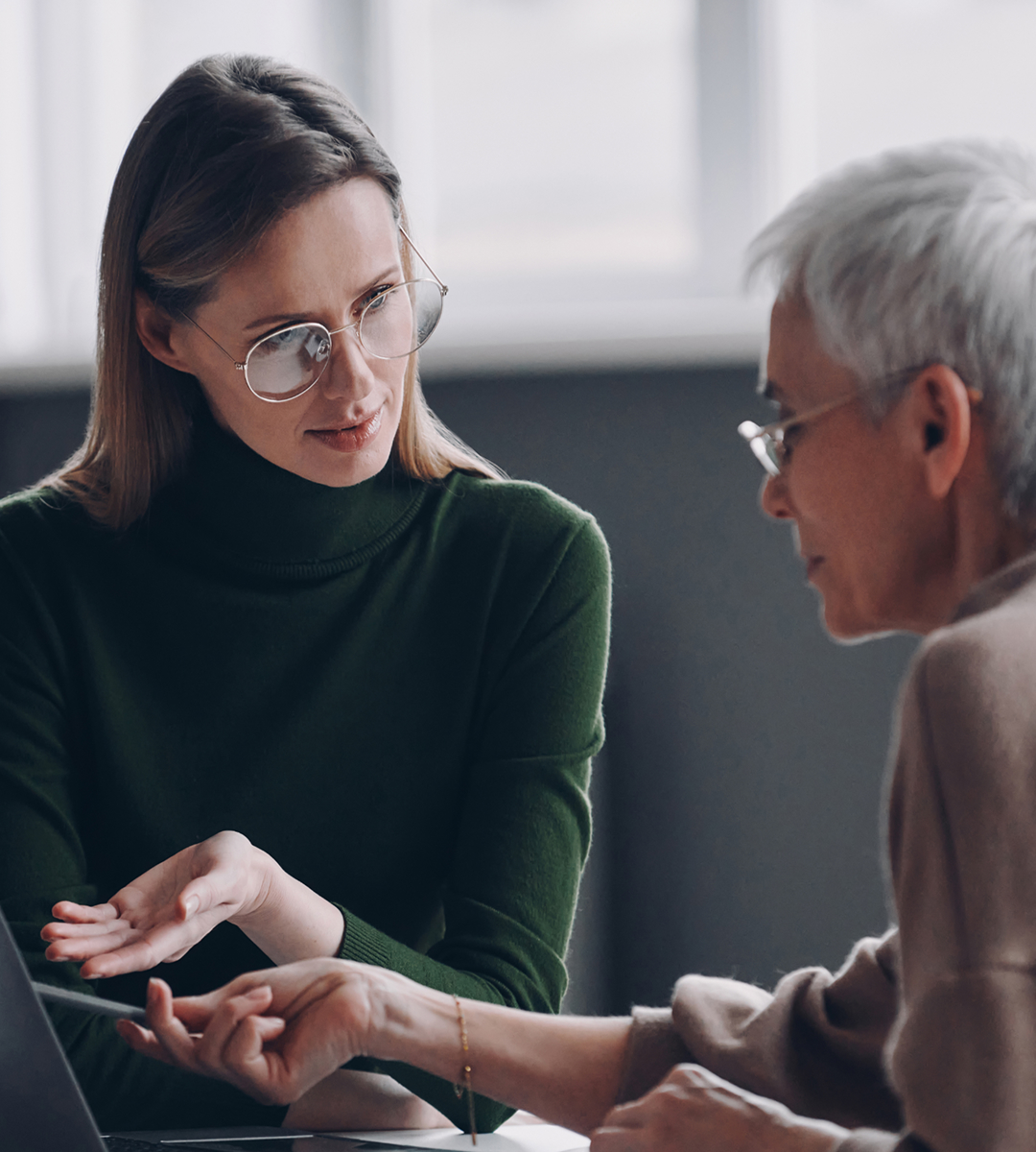 woman dressed with green and glasses looking at man at with black half overlay alt